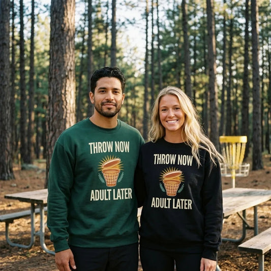 Throw Now Adult Later disc golf retro crewneck sweatshirt — two friends at the disc golf course, Forest Green and Black