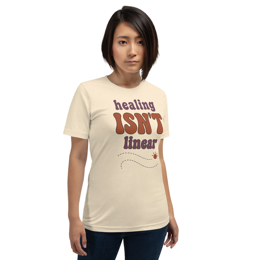 Healing Isn't Linear soft retro mental health tee — Heather Natural, on model