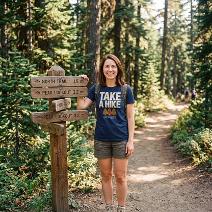 Take a Hike retro outdoors humor typography tee — woman at a forest trailhead with trail signpost, Navy