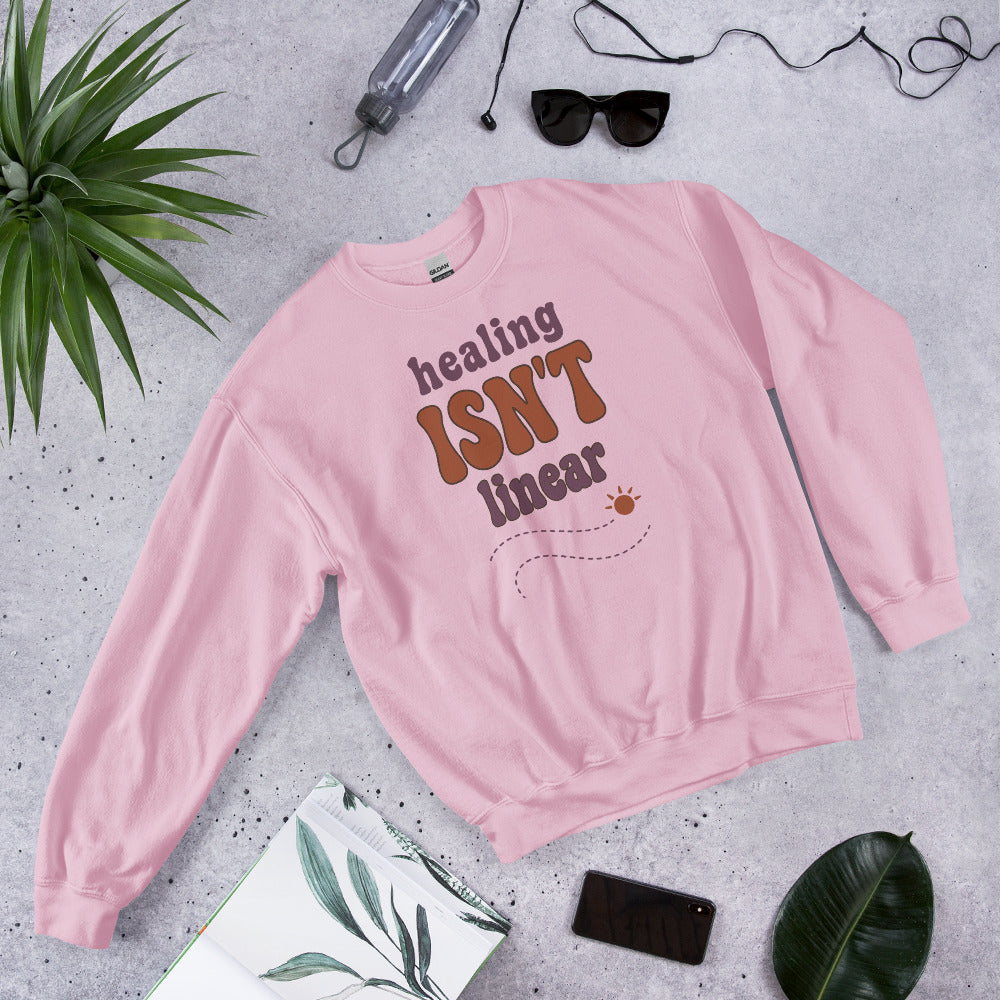 Healing Isn't Linear soft retro mental health crewneck sweatshirt — Light Pink, front angled