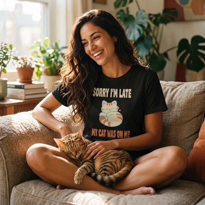Sorry I'm Late My Cat Was On Me funny cat mom t-shirt — lifestyle, Latina woman relaxing on a sofa with a tabby cat