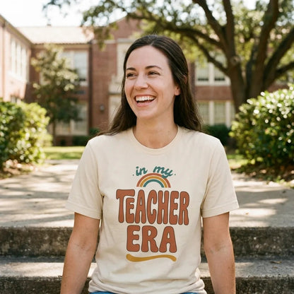 In My Teacher Era retro groovy teacher tee — teacher on sunny school steps, Soft Cream