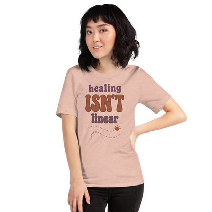 Healing Isn't Linear soft retro mental health tee — Heather Prism Peach, on model