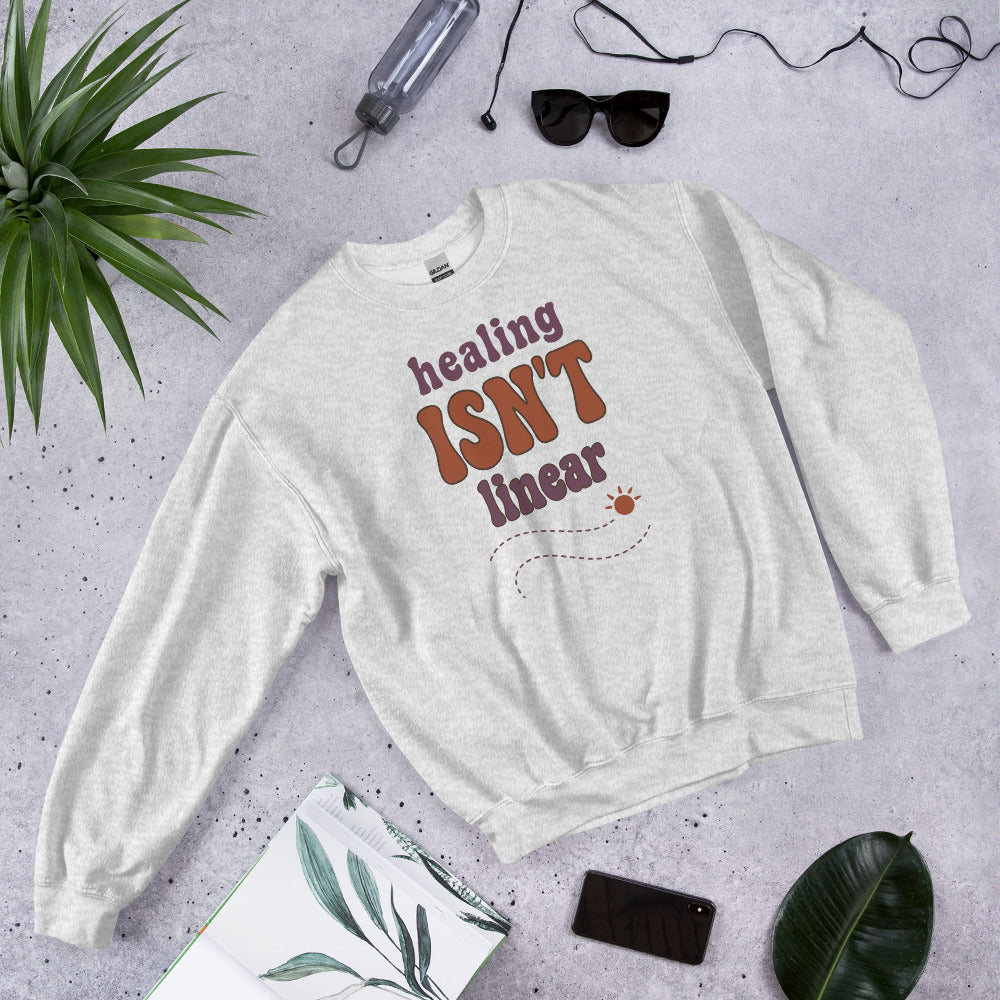 Healing Isn't Linear soft retro mental health crewneck sweatshirt — Ash, front angled