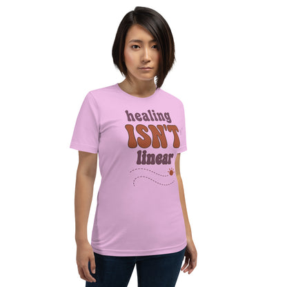 Healing Isn't Linear soft retro mental health tee — Lilac, on model