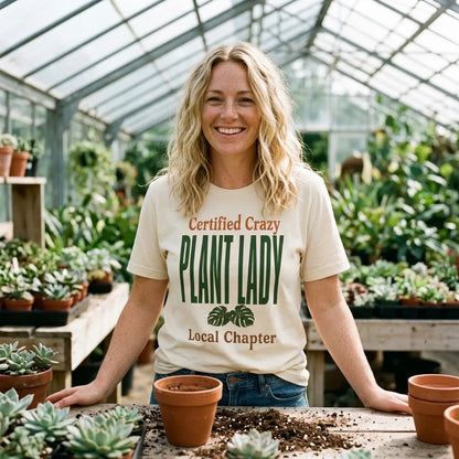 Certified Crazy Plant Lady retro botanical tee — woman at a greenhouse potting bench, Natural