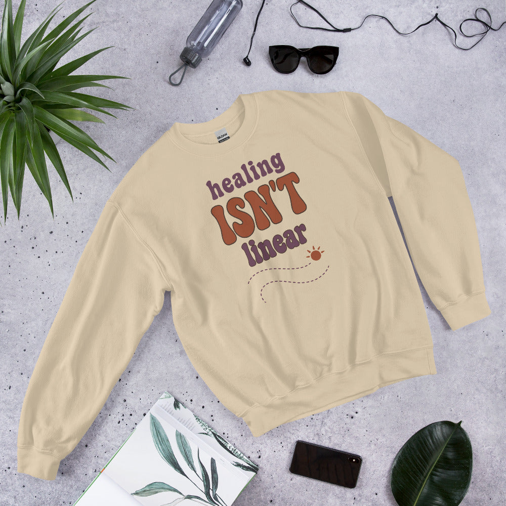 Healing Isn't Linear soft retro mental health crewneck sweatshirt — Sand, front angled