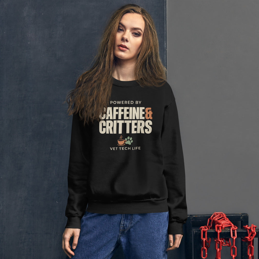Powered by Caffeine & Critters funny vet tech crewneck sweatshirt — Black, on model