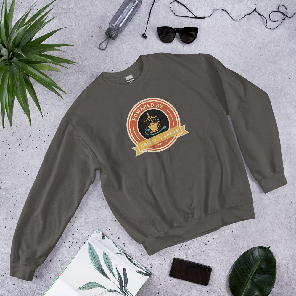 Powered by Coffee & Chaos retro nurse badge crewneck sweatshirt — Charcoal, front-right