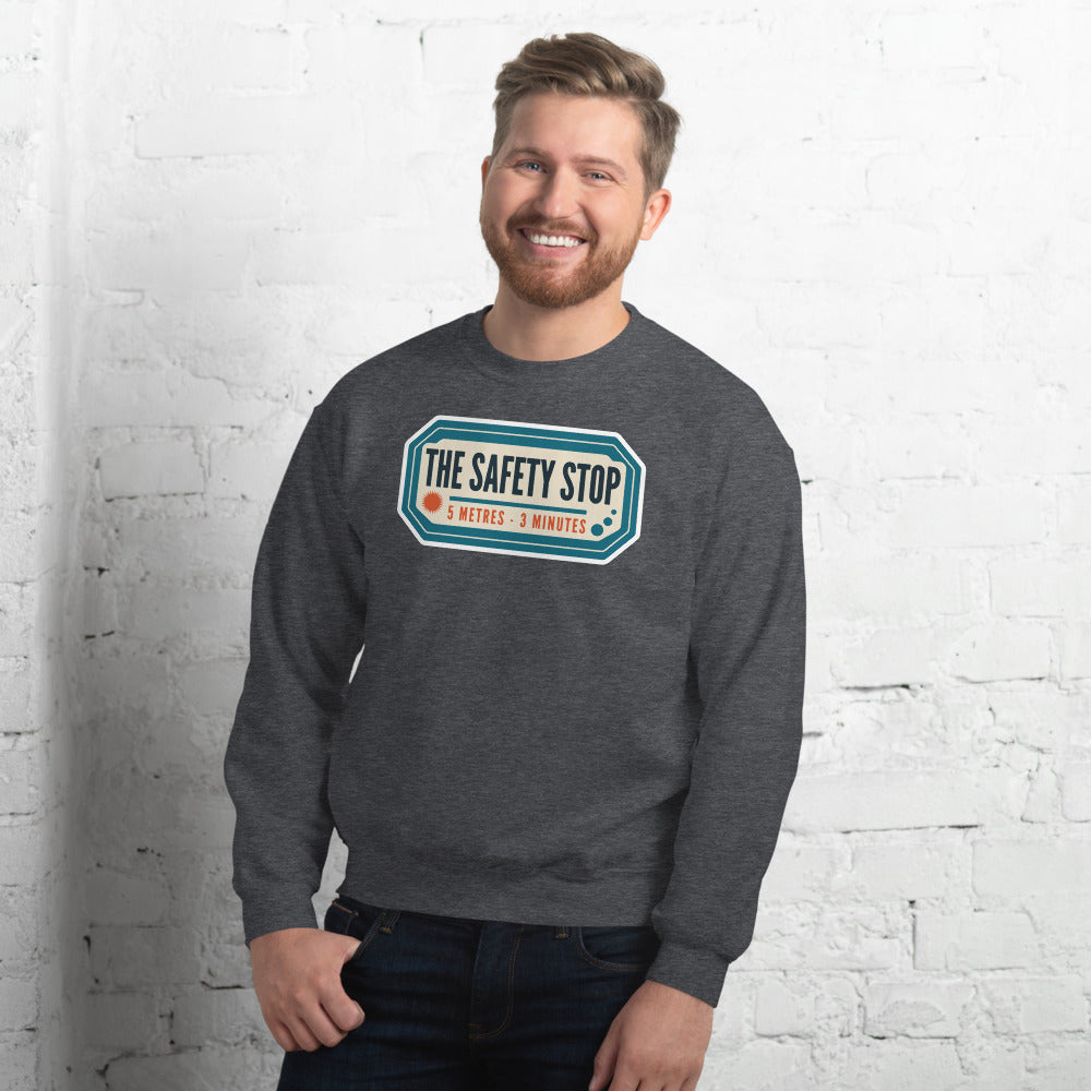 The Safety Stop vintage scuba diving travel decal sweatshirt — Dark Heather, on model