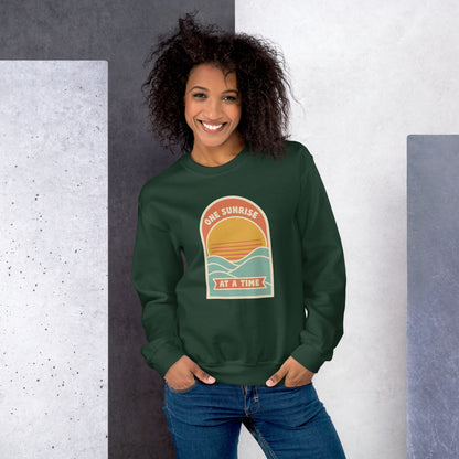 One Sunrise at a Time retro sunrise crewneck sweatshirt — Forest Green, on model
