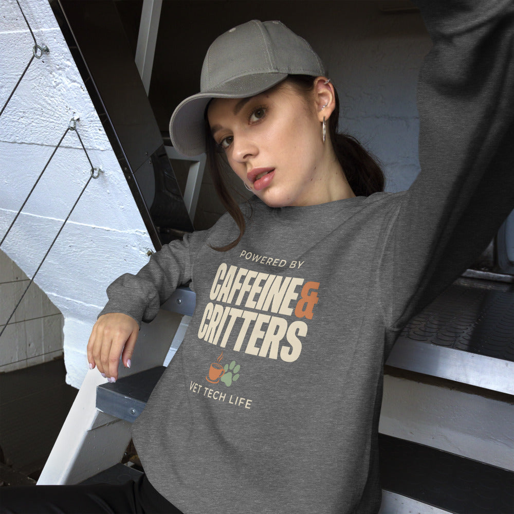 Powered by Caffeine & Critters funny vet tech crewneck sweatshirt — Graphite Heather, on model