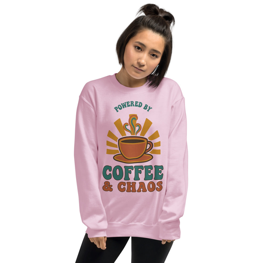 Model wearing Powered By Coffee And Chaos retro groovy teacher crewneck sweatshirt — Light Pink