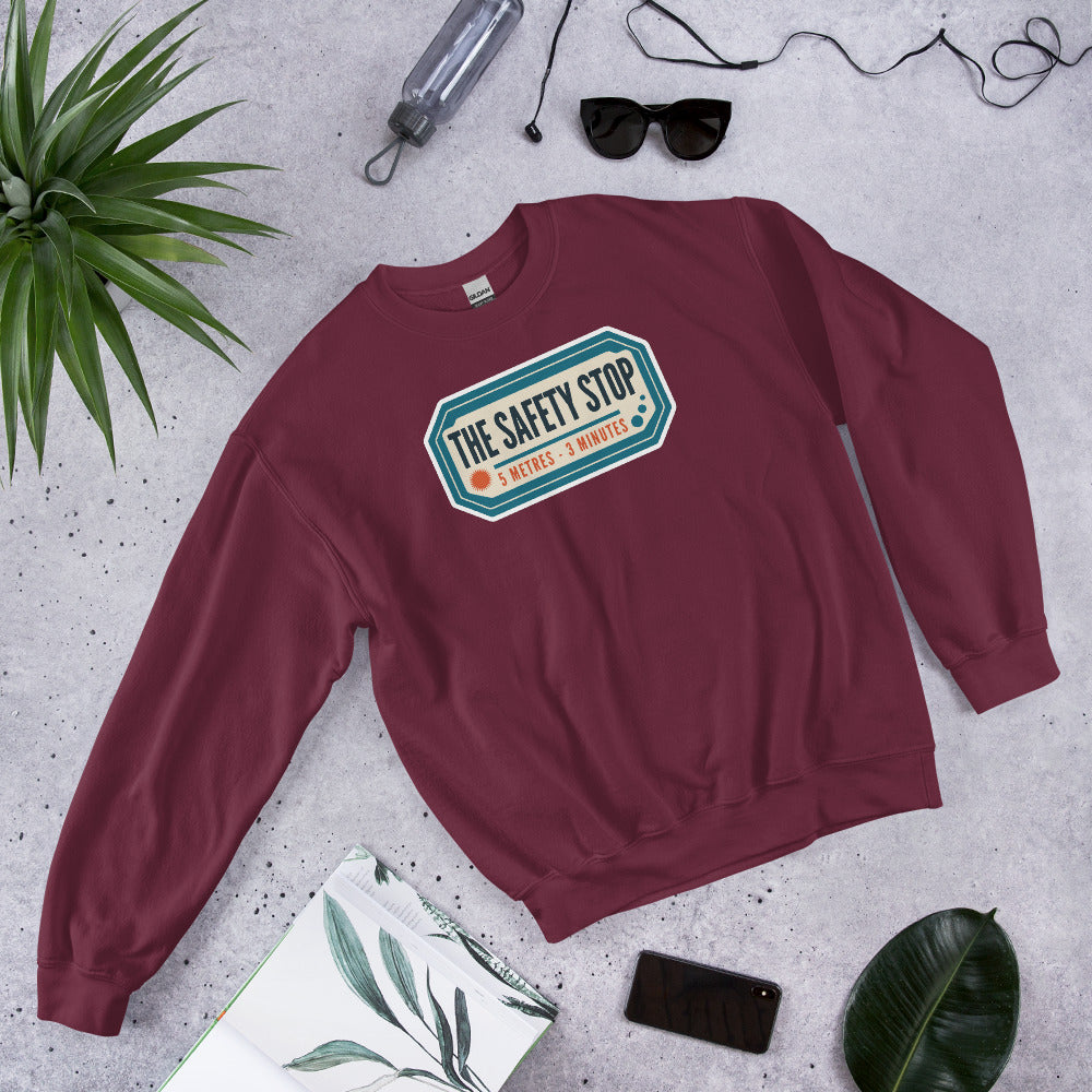 The Safety Stop vintage scuba diving travel decal sweatshirt — Maroon, flat lay