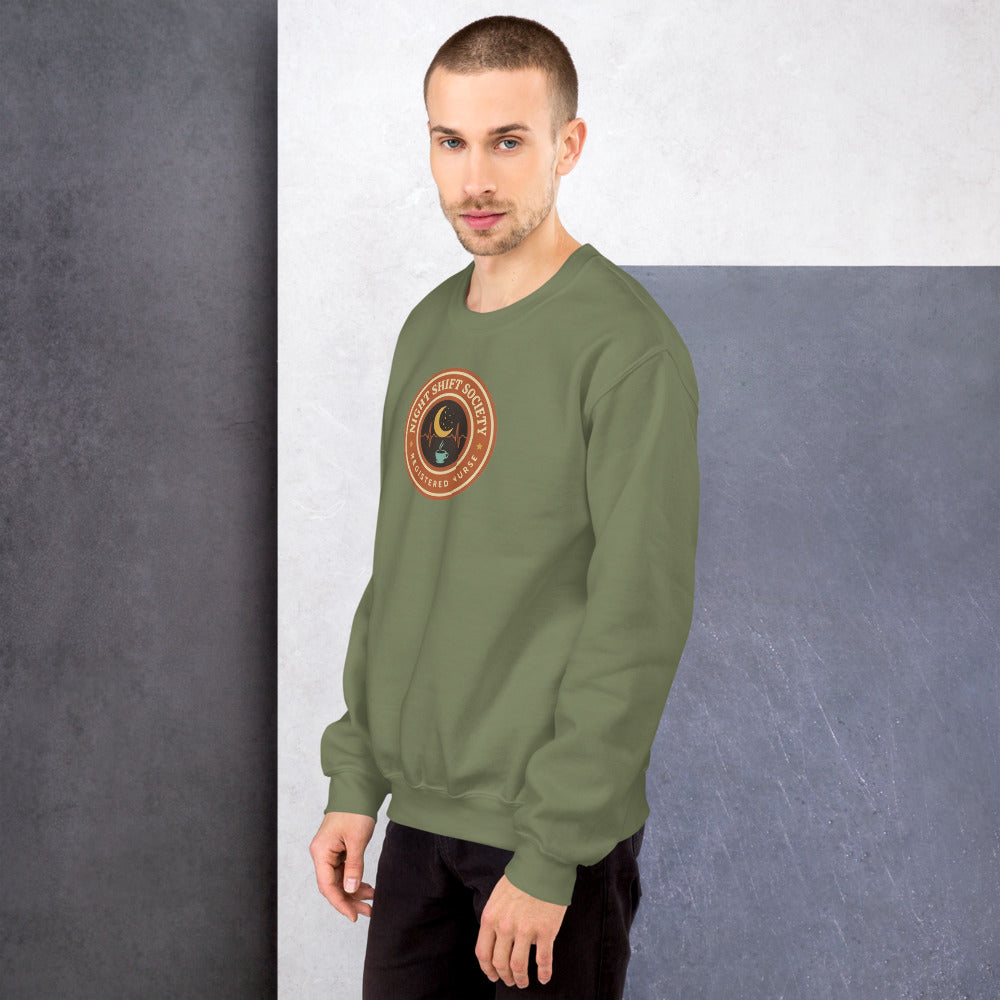 Night Shift Society retro registered nurse badge crewneck sweatshirt — Military Green, on model