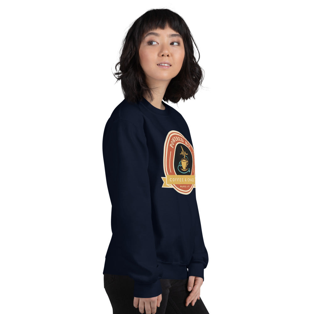 Powered by Coffee & Chaos retro nurse badge crewneck sweatshirt — Navy, on model