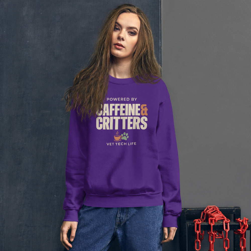 Powered by Caffeine & Critters funny vet tech crewneck sweatshirt — Purple, on model