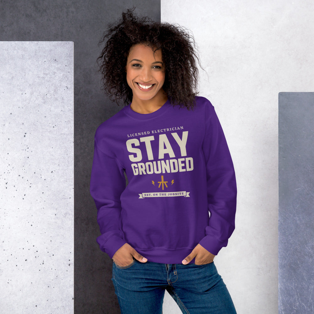 Stay Grounded funny electrician crewneck — Purple, on model