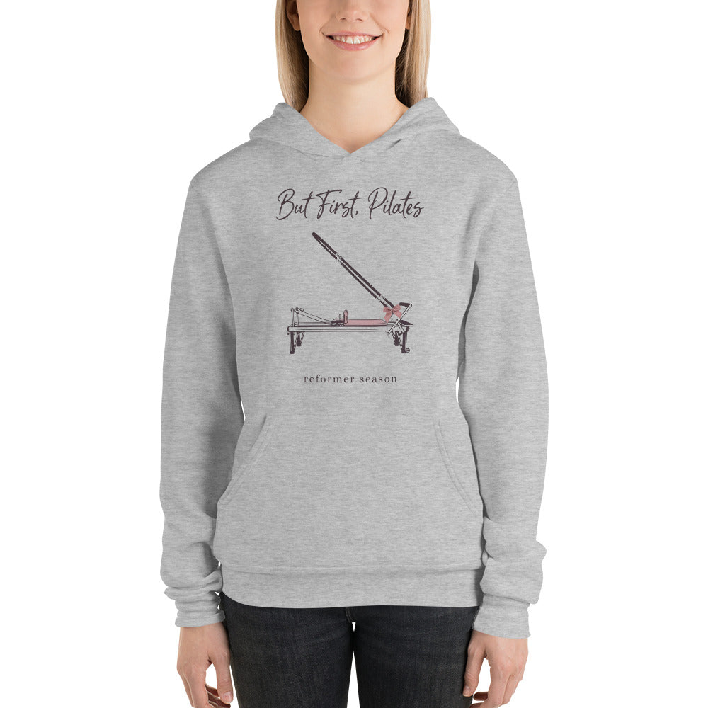 But First Pilates reformer line-art hoodie — Athletic Heather, on model