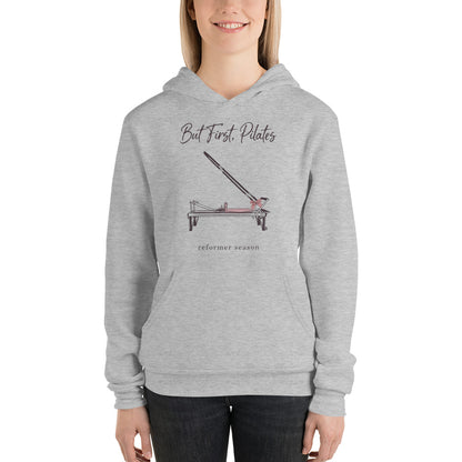 But First Pilates reformer line-art hoodie — Athletic Heather, on model