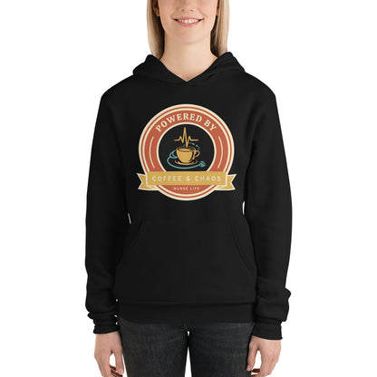 Powered by Coffee & Chaos retro nurse badge hoodie — Black, on model