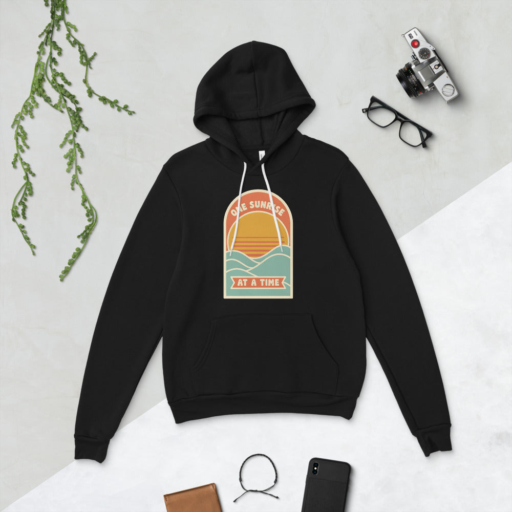 One Sunrise at a Time retro sunrise hoodie — Black, flat lay