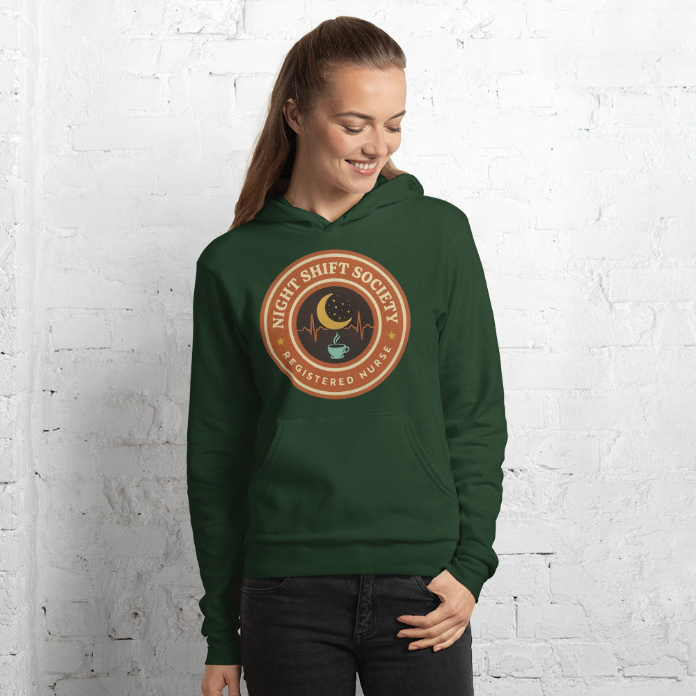 Night Shift Society retro registered nurse badge hoodie — Forest, on model