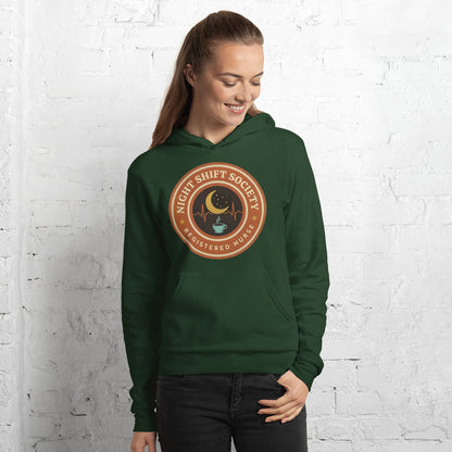 Night Shift Society retro registered nurse badge hoodie — Forest, on model