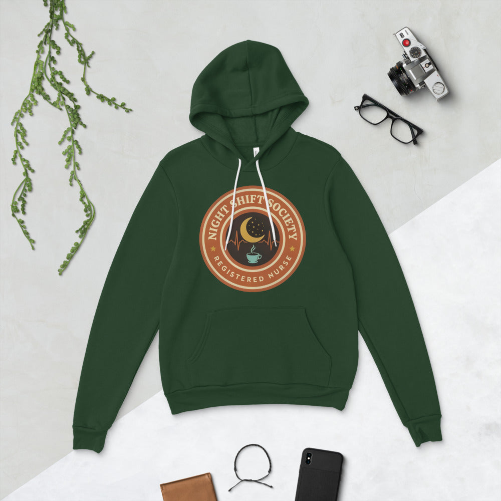 Night Shift Society retro registered nurse badge hoodie — Forest, flat lay