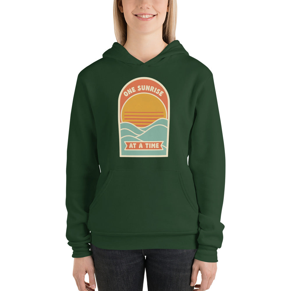 One Sunrise at a Time retro sunrise hoodie — Forest, on model
