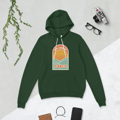 One Sunrise at a Time retro sunrise hoodie — Forest, flat lay
