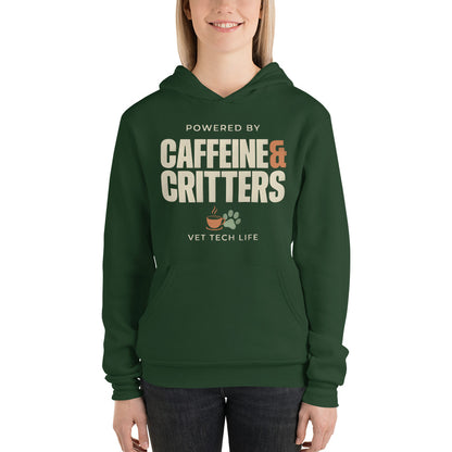 Powered by Caffeine & Critters funny vet tech hoodie — Forest, on model