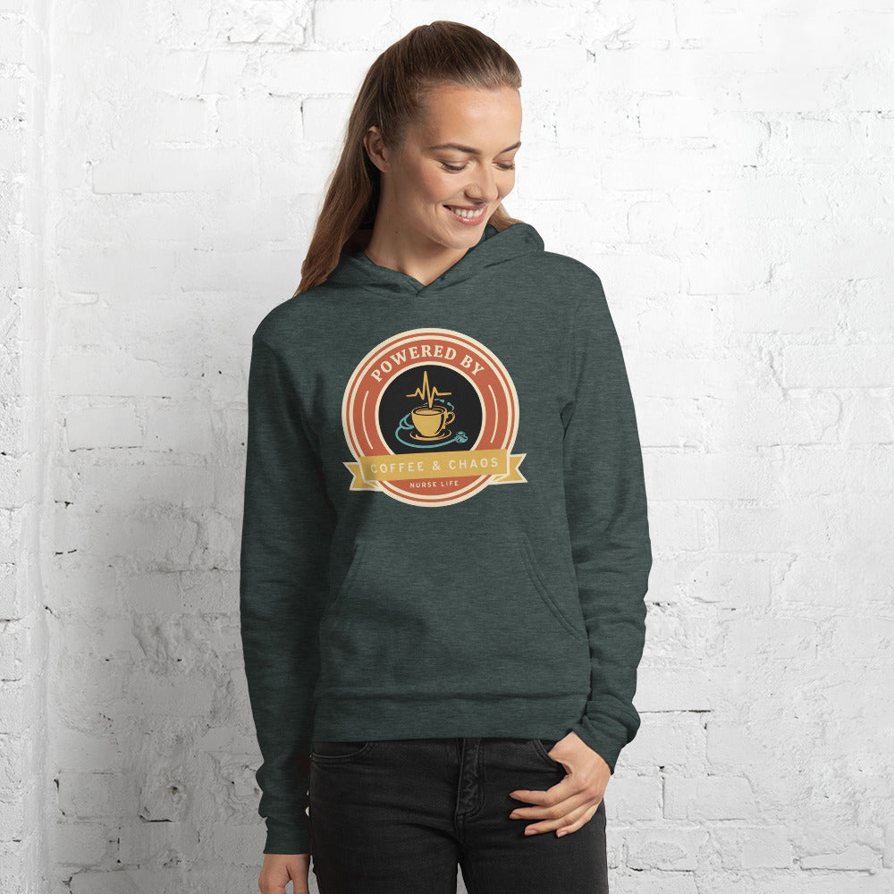 Powered by Coffee & Chaos retro nurse badge hoodie — Heather Forest, on model