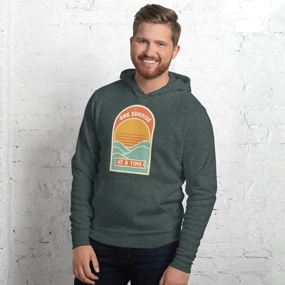 One Sunrise at a Time retro sunrise hoodie — Heather Forest, on model
