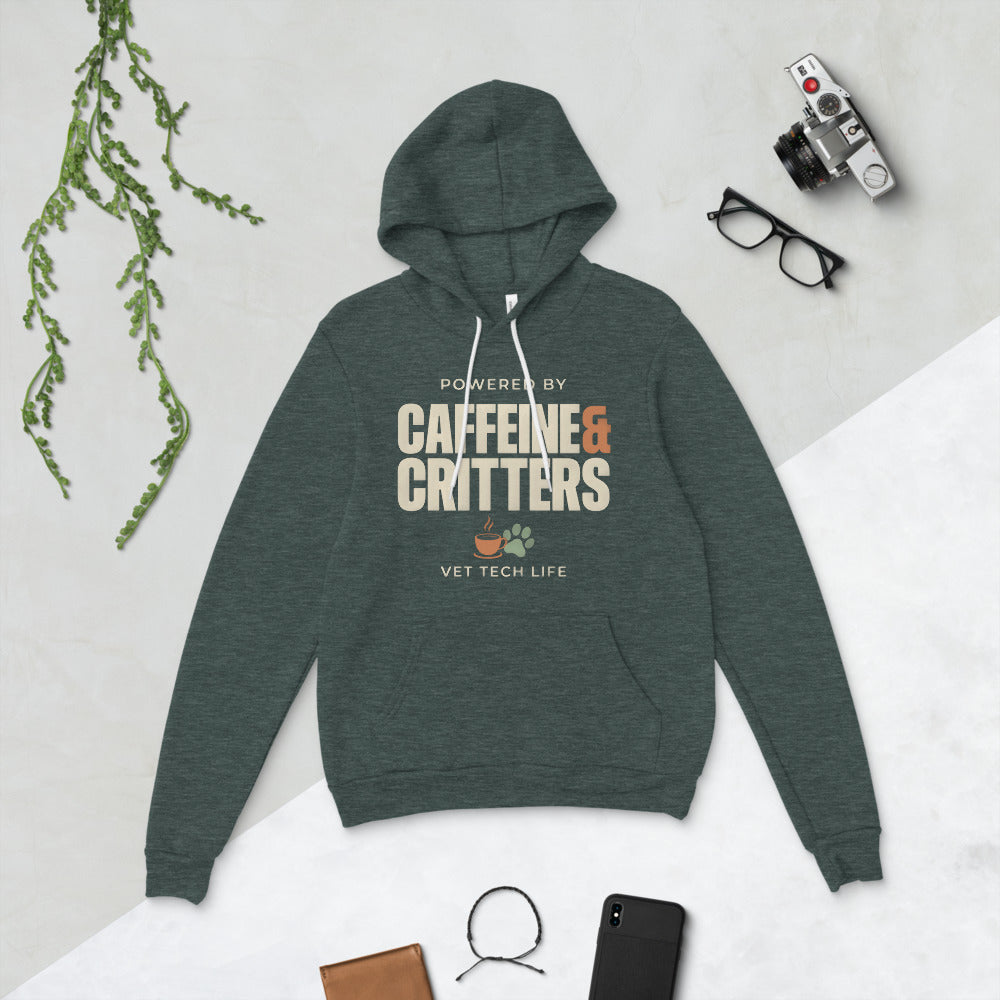 Powered by Caffeine & Critters funny vet tech hoodie — Heather Forest, flat lay