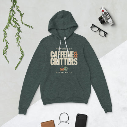 Powered by Caffeine & Critters funny vet tech hoodie — Heather Forest, flat lay