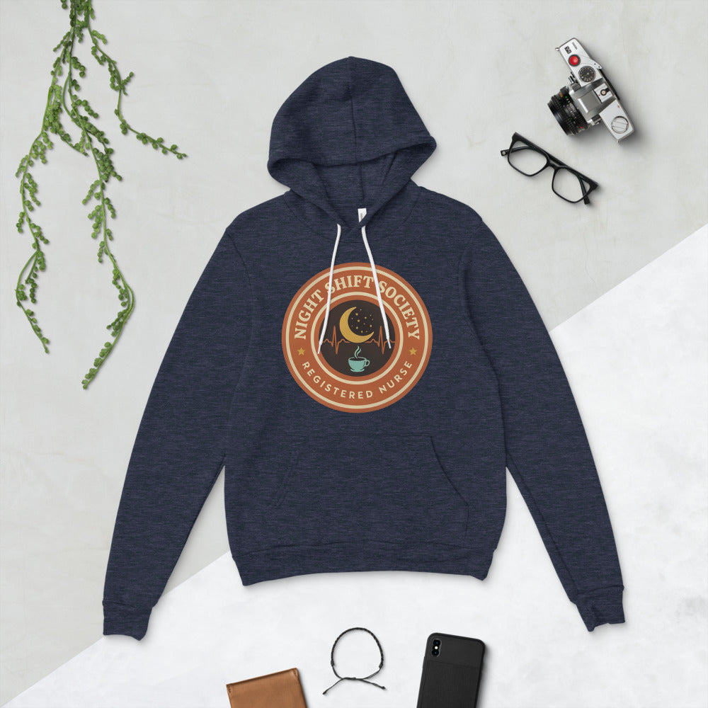 Night Shift Society retro registered nurse badge hoodie — Heather Navy, flat lay