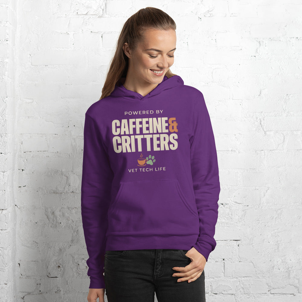 Powered by Caffeine & Critters funny vet tech hoodie — Team Purple, on model