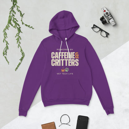 Powered by Caffeine & Critters funny vet tech hoodie — Team Purple, flat lay