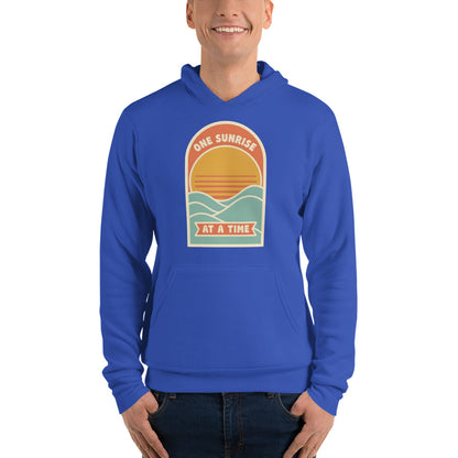 One Sunrise at a Time retro sunrise hoodie — True Royal, on model