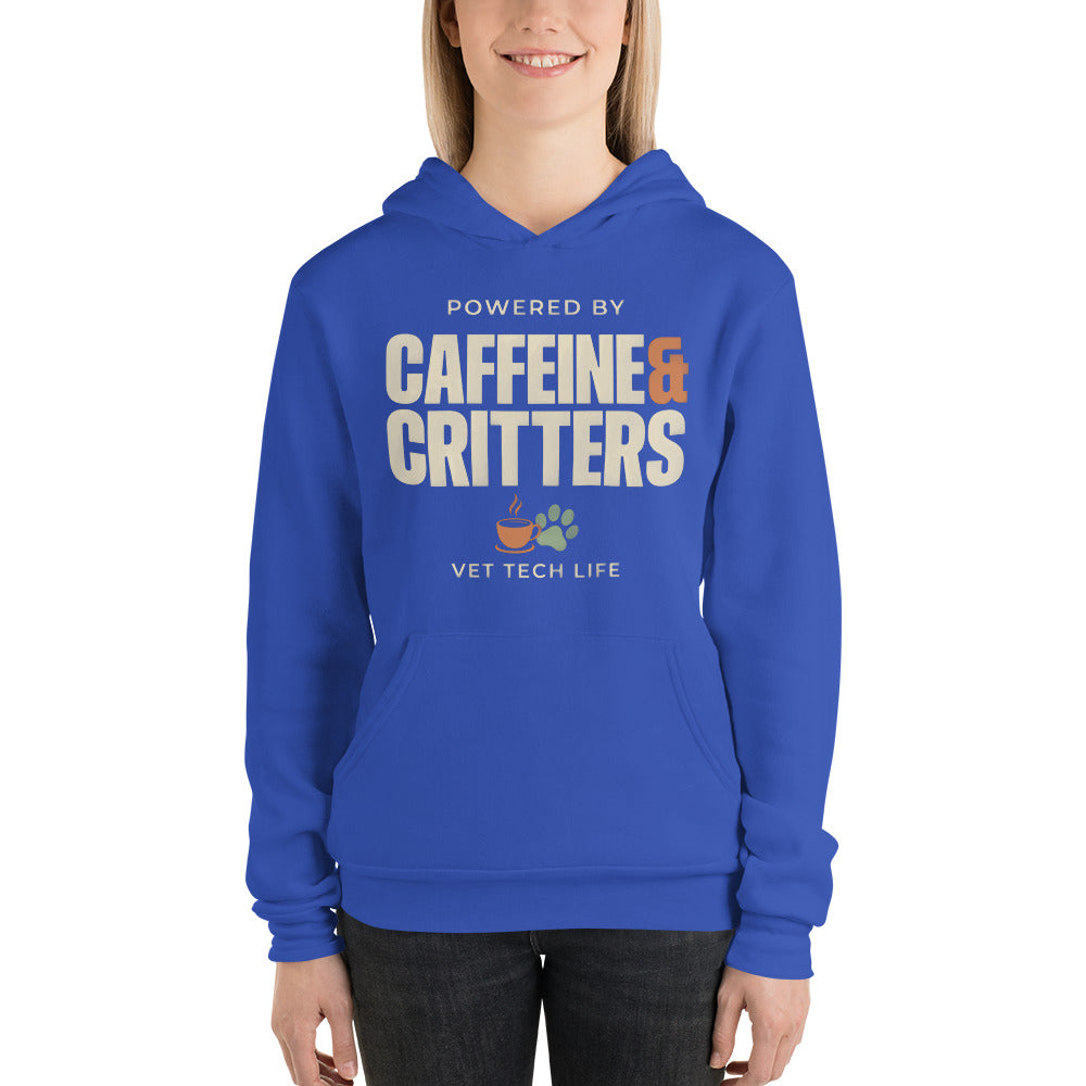 Powered by Caffeine & Critters funny vet tech hoodie — True Royal, on model