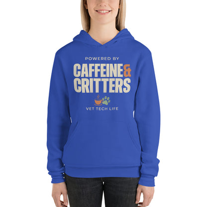 Powered by Caffeine & Critters funny vet tech hoodie — True Royal, on model