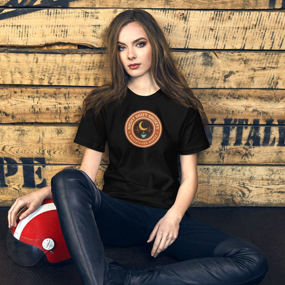 Night Shift Society retro registered nurse badge tee — Black, on model