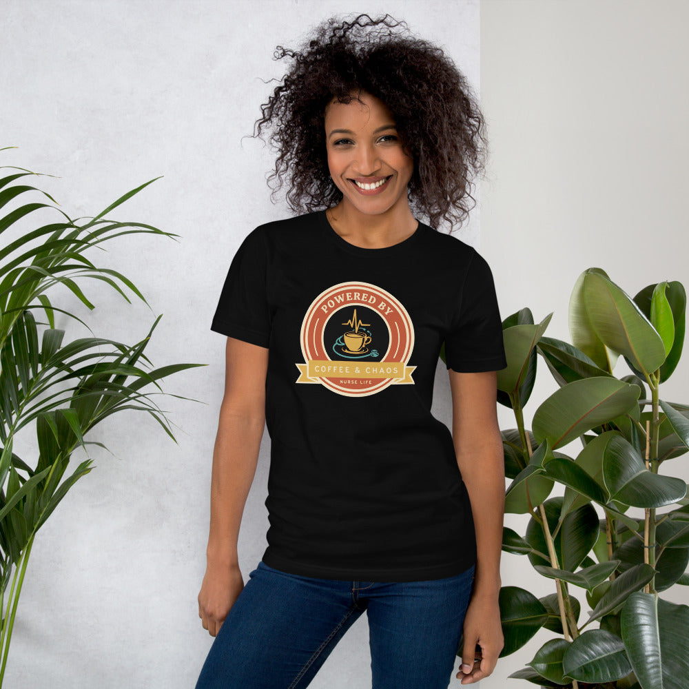 Powered by Coffee & Chaos retro nurse badge tee — Black, on model