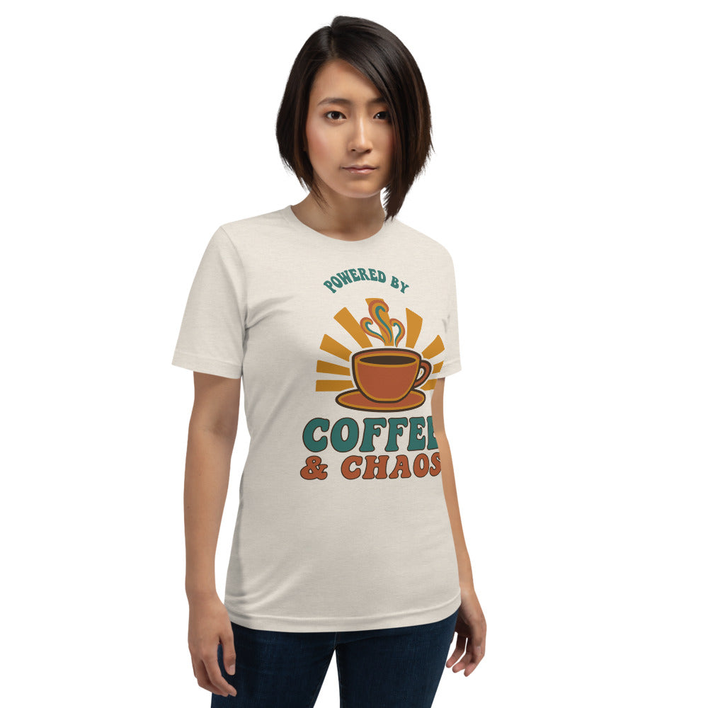 Powered By Coffee And Chaos retro groovy teacher tee — Heather Dust, on model