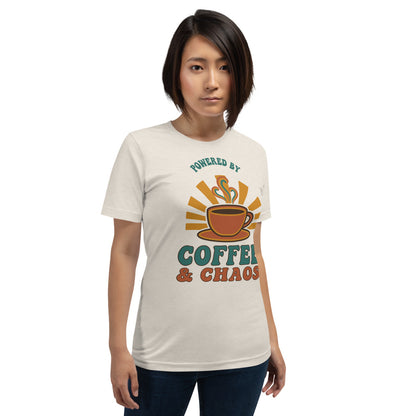Powered By Coffee And Chaos retro groovy teacher tee — Heather Dust, on model