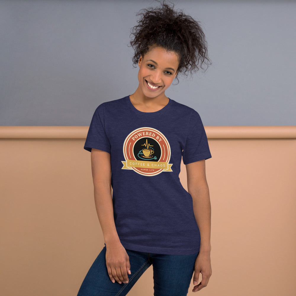 Powered by Coffee & Chaos retro nurse badge tee — Heather Midnight Navy, on model
