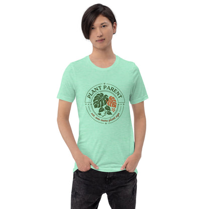 Model wearing the Plant Parent retro botanical badge tee — Heather Mint