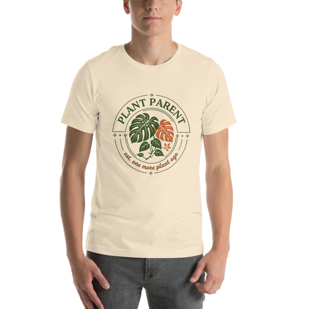 Model wearing the Plant Parent retro botanical badge tee — Heather Natural