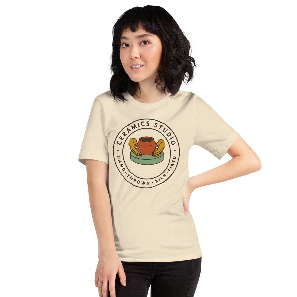 Ceramics Studio Badge hand-thrown pottery t-shirt — Heather Natural, on model